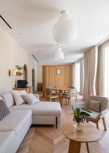a living room with a couch and a table at Boutique-Hôtel Le N3 par Champagne Thiénot in Reims