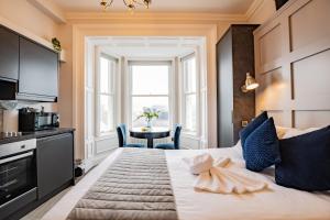 a bedroom with a bed with a window and a table at Superb Marina Hideaway- With kitchen and Wi-Fi in Dublin