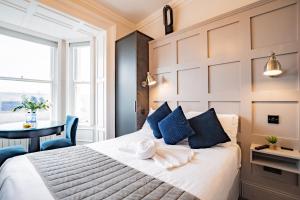 a bedroom with a bed and a table and a window at Superb Marina Hideaway- With kitchen and Wi-Fi in Dublin