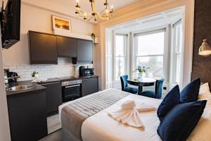 a bedroom with a large bed and a kitchen at Superb Marina Hideaway- With kitchen and Wi-Fi in Dublin +15 photos