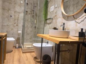 a bathroom with a sink and a shower and a toilet at Affittacamere Osimo Rose in Osimo +9 photos