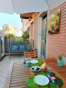 a table with plates of food on a patio at Affittacamere Osimo Rose in Osimo