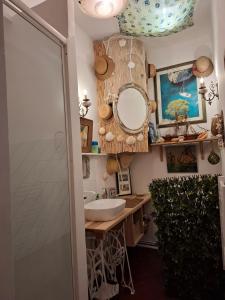 a bathroom with a sink and a mirror at La Maison du Chichui in Orgon +30 photos