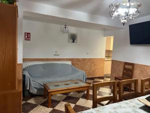 a bedroom with a bed and a table in a room at Cortijo rural Los Pinos in Villanueva de Algaidas