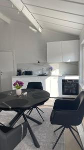 a kitchen with a table and chairs in a room at Dune Nest 233 - beautiful house near beach - up to 4 guests with garden, parking, WLAN in Bredene