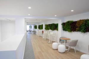 a room with a row of plants on the wall at BLUESEA Mediodia in El Arenal +13 photos