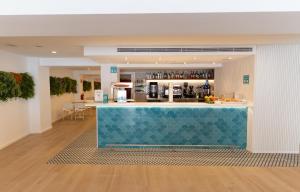 a bar with a blue counter in a room at BLUESEA Mediodia in El Arenal