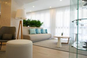 a living room with a couch and a table at BLUESEA Mediodia in El Arenal