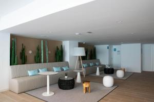 a living room with a couch and a table at BLUESEA Mediodia in El Arenal