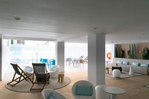 a living room with chairs and a dining room at BLUESEA Mediodia in El Arenal