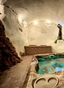 a bathroom with a jacuzzi tub in a cave at La Bombonière & Spa in Roquebrune-Cap-Martin