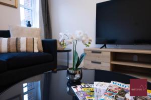 a living room with a coffee table and a tv at Hook Three Bed Flat Parking in Hook
