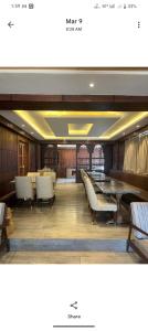 a dining room with tables and chairs and benches at Pine Breeze Luxe in Gulmarg
