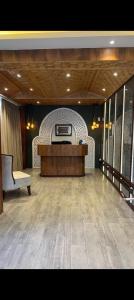 a large room with a stage and a couch in it at Pine Breeze Luxe in Gulmarg