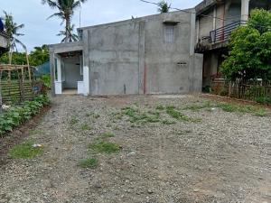 an empty yard in front of a building at cavinitan transient house in Virac