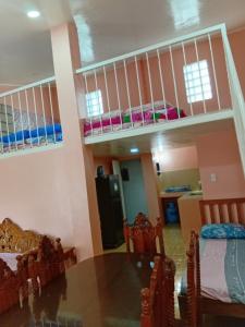 a dining room and living room with a table and bunk beds at cavinitan transient house in Virac