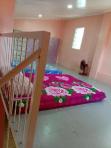 a bedroom with a bunk bed with a pink blanket at cavinitan transient house in Virac