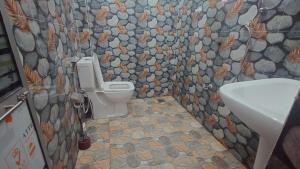 a bathroom with a toilet and a sink at ELEPHANT Orphanage View in Udawalawe