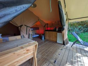 an inside of a tent with a wooden floor at Camping Naéco Audierne in Plouhinec