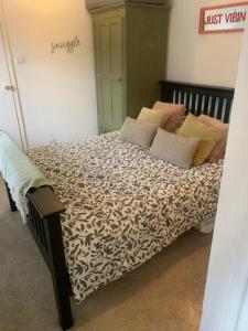 a bed with pillows on it in a bedroom at 1 mile from Harry Potter Tour Self Contained Flat One bedroom plus new sofa bed in lounge in Abbots Langley