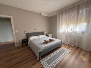 a bedroom with a bed with two shoes on it at Colibrì Art B&B in San Martino in Argine