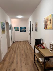 a hallway with paintings on the walls of a room at Colibrì Art B&B in San Martino in Argine