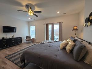 a bedroom with a large bed with a ceiling fan at Waterfront Retreat One in Rocky Mount