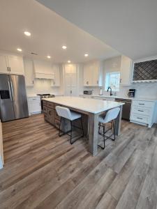 a large kitchen with a large table and two chairs at Waterfront Retreat One in Rocky Mount