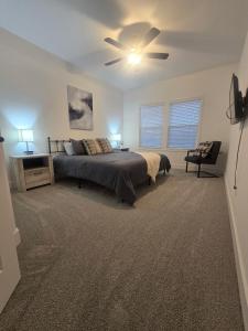 a bedroom with a bed and a ceiling fan at Waterfront Retreat One in Rocky Mount