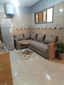 a living room with a couch and a table at Nomad Surf Morocco in Imsouane