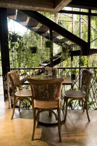 a table and chairs in a room with a balcony at Carriqui Garden Hotel in Pereira +126 photos