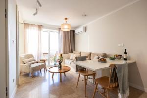 a living room with a couch and a table at Zelena Punta Resort in Kukljica