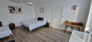 a bedroom with a bed and a desk in it at Maison du Gué 2 chambres in Gurgy