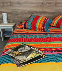 a magazine sitting on top of a bed at La Escala in La Celle-sous-Gouzon