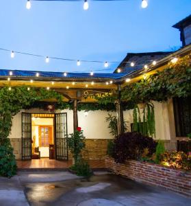 a house with a patio with lights and plants at Lar Antiqua Hotel in Quetzaltenango