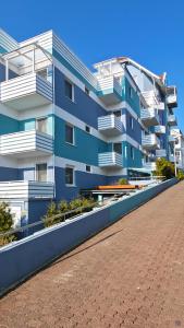 a blue building with white balconies and a sidewalk at Hotel Sofia in Bad Wildungen