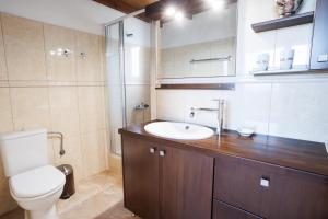 a bathroom with a toilet and a sink at Villa Sofia Almyrida in Almyrida +49 photos