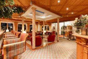 a living room with couches and chairs at Hotel Neuhäusl - herzlich familiär in Berchtesgaden