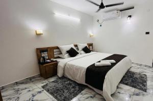 a bedroom with a large bed with two towels on it at Sea View Varkala Beach Resort in Varkala