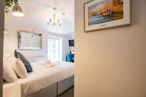 a bedroom with a bed and a picture on the wall at Charming Howth Marina Retreat in Dublin