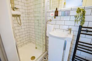 a bathroom with a shower and a sink at Charming Howth Marina Retreat in Dublin