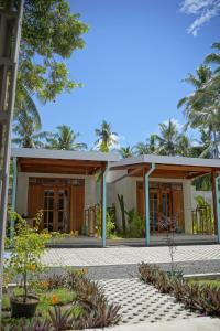 a view of a building with trees in the background at Pam's Cabin Batukaras in Batukaras