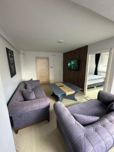 a living room with a couch and a table at Marin konaklama in Pendik