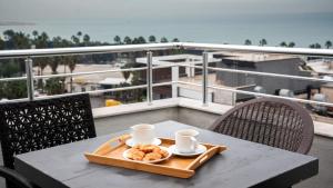 a tray of donuts on a table on a balcony at We Nirvana Otel in Mezitli