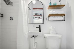a bathroom with a sink and a toilet and a mirror at Twilight Ranch Tiny Homes - pet friendly & hill country views in Fredericksburg +12 photos