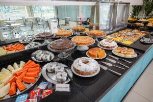 a buffet filled with different types of desserts and cakes at Garcia Palace Hotel in Sinop