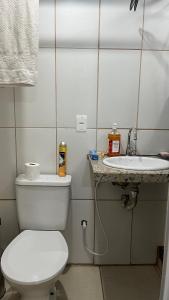 a bathroom with a toilet and a sink at Na Ladeira Studio 01 Rua Miguel Rangel 660 casa 26 in Rio de Janeiro