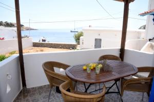 a table on a balcony with a view of the ocean at Anna Rooms Kythnos in Kanala +45 photos