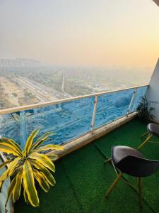 a balcony with a chair and a plant on a building at Mansion Grey Studio in Ghaziabad