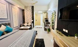 a bedroom with a bed and a living room at Mansion Grey Studio in Ghaziabad